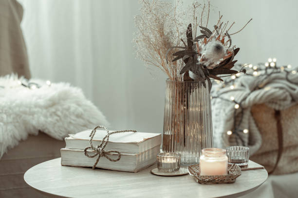 Cozy home composition with books, candles and decor details. Details of home decor interior in a Scandinavian style on a blurred background of the room. coffee table top stock pictures, royalty-free photos & images