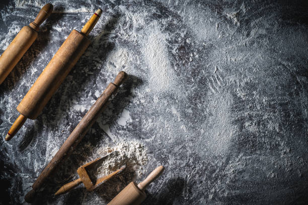 istock Rolling pin and flour serving scoop on flour spread background abstract for bakery themes 1333259347