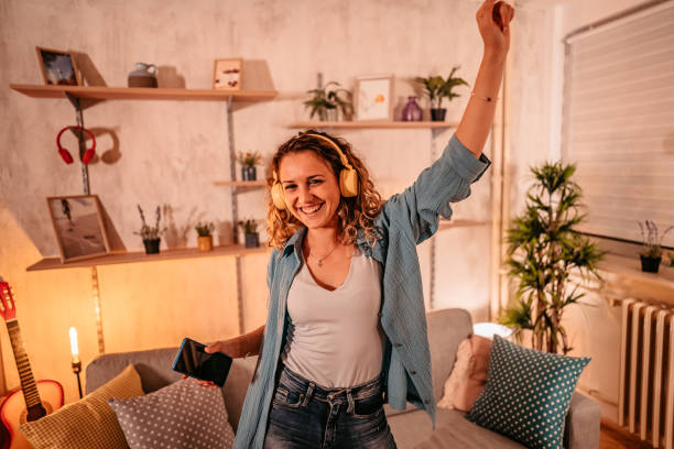 istock Woman singing and dancing at home 1333259995