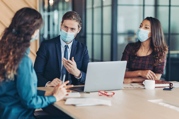 istock Business persons wearing protective masks having a meeting 1333260476