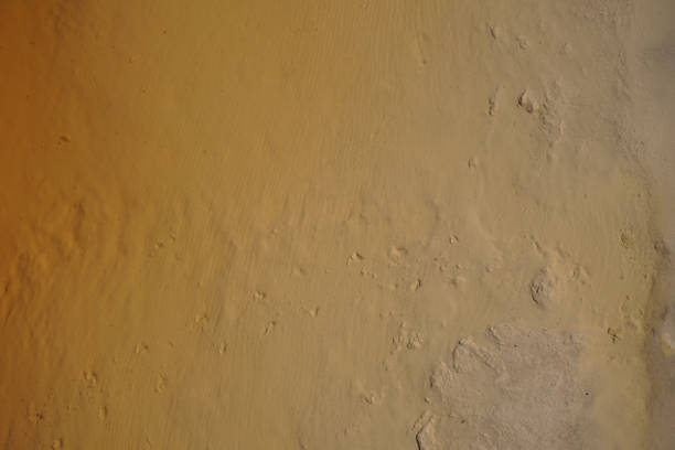 Clay covered with water. Footprints in clay.