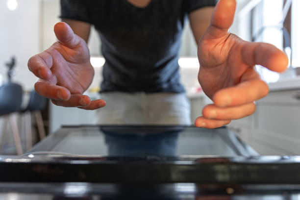 istock Male hands reach for the open oven to get something. 1333261626