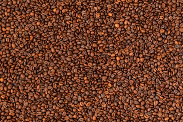 istock Fresh roasted coffee beans background. Top view. 1333262032