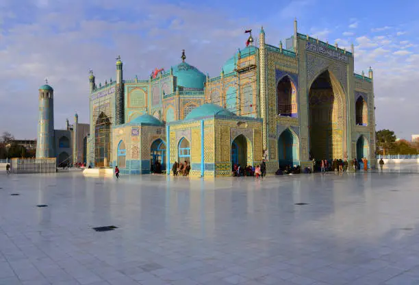 Mazar-i-Sharif, Balkh province, Afghanistan: Shrine of Ali (Hazrat Ali Mazar) - with many pilgrims around the building, none standing out - also known as the Blue Mosque, considered (mainly by the Afghans) as the burial place of Ali ibn Abi Talib, the son-in-law of Muhammad, the most important pilgrimage site in Afghanistan. The Imam Ali mosque in Najaf in Iraq is considered many as the the burial place of Ali.