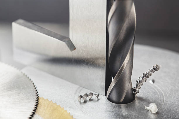 istock Drill bit with steel triangle ruler make holes in steel billet on industrial drilling machine.Metal work industry. multi cutting tool and end mill. 1333265285