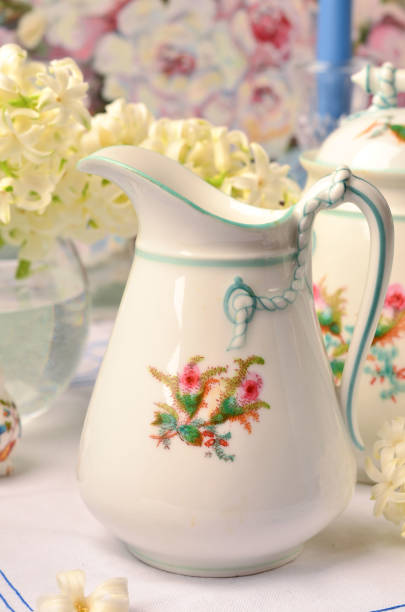 istock White porcelain creamer in the composition on the table 1333265834