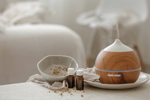 spa composition with air humidifier and essential oils. - aromatic oil burner imagens e fotografias de stock