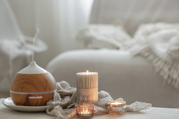 cozy home composition with air humidifier and candles on blurred background. - aromatic oil burner imagens e fotografias de stock