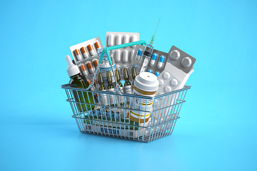 Shopping basket full of medicines, pills, blisters and vaccine on blue background. 3d illustration