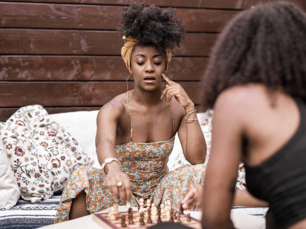 istock Young African woman playing chess in back yard 1333266856