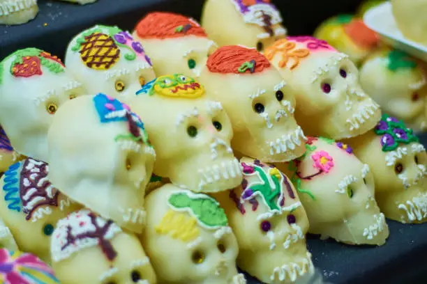 Photo of Set of sugar skulls in the market. Day of the Dead concept. Día de Muertos, Calaveritas de Azúcar.