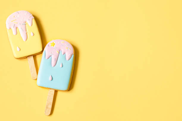 Flat lay of ice cream cookies on yellow background.