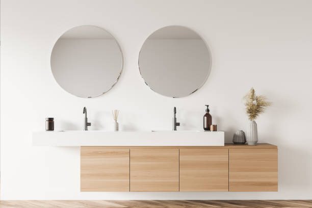 istock Light beige bathroom wall with original vanity and round mirrors 1333269017