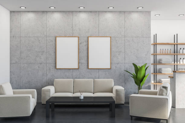 Two posters in the lobby with light beige sofa, armchairs