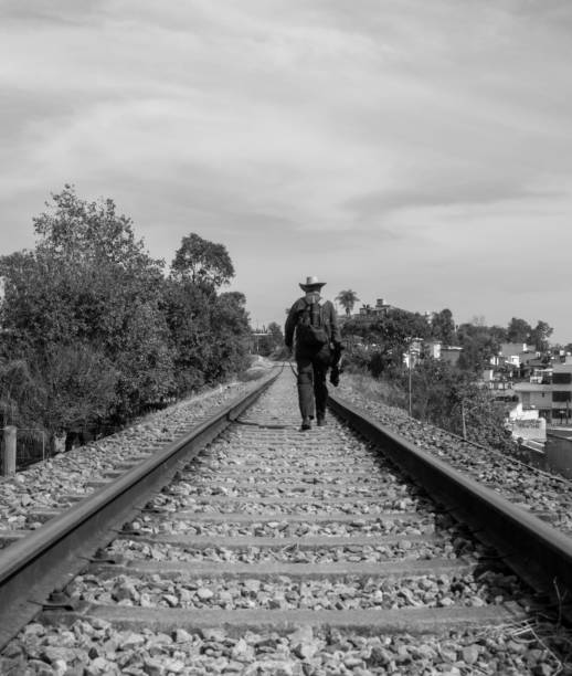 Business man between two fast trains black and white