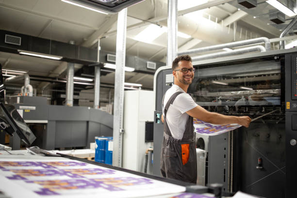 istock Worker taking imprint from modern printing machine to do color matching and quality control. 1333272068