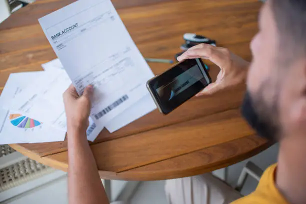 Man paying bills by phone