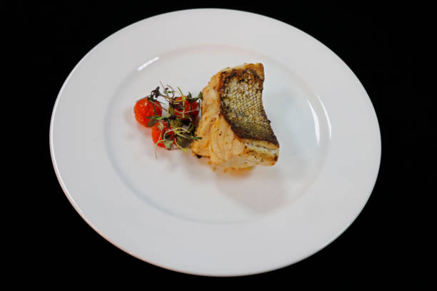 istock grilled atlantic cod fish fillet on a white plate with cherry tomato 1333278309