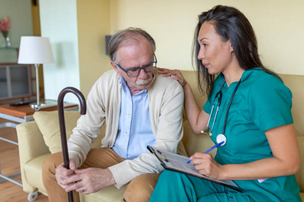 Sick Old Man is Receiving Advice From Nurse in Home Visit.