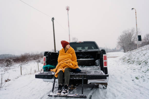istock Young woman on a winter road trip 1333279131