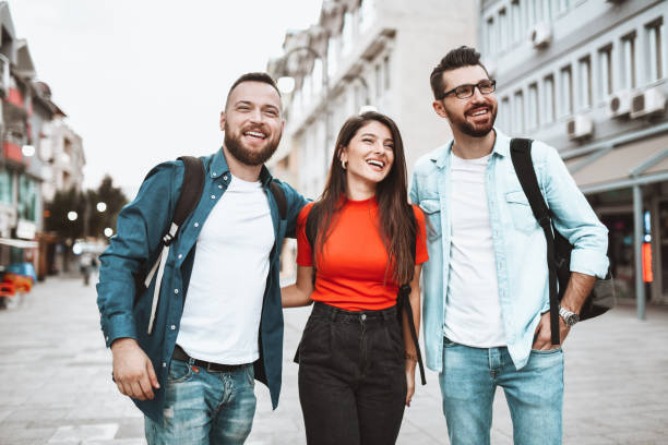 istock Embracing Friends Smiling While Sightseeing New Town As Tourists 1333279884