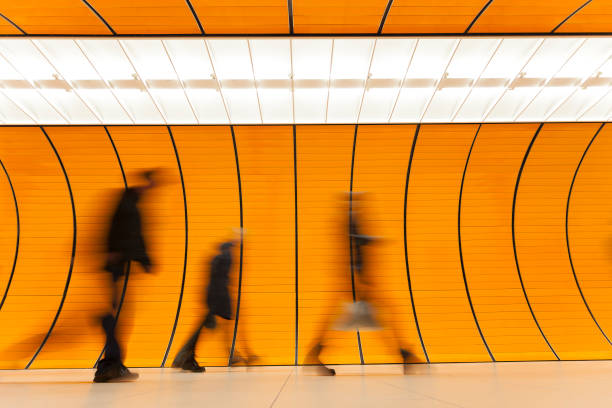 Commuters Rushing Against Modern Orange Background, Subway Station