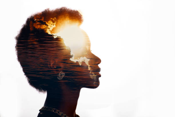 Multiple exposure image with sunrise and sea inside woman silhouette. Psychology and mindset concept stock photo