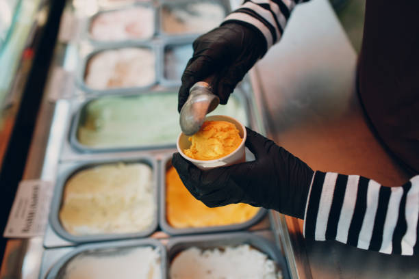 istock ice cream maker lays multicolored ice cream outside cup 1333284178