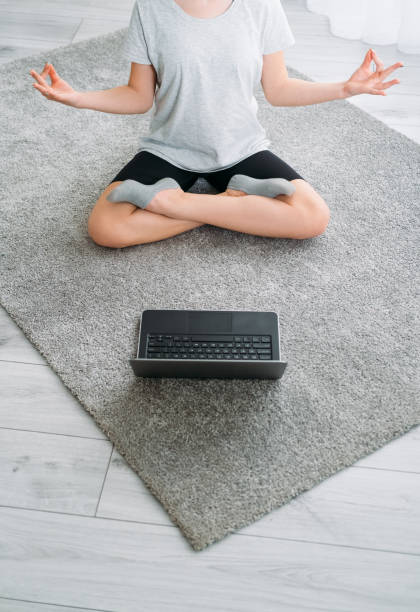 istock online meditation home yoga girl tutorial laptop 1333284227