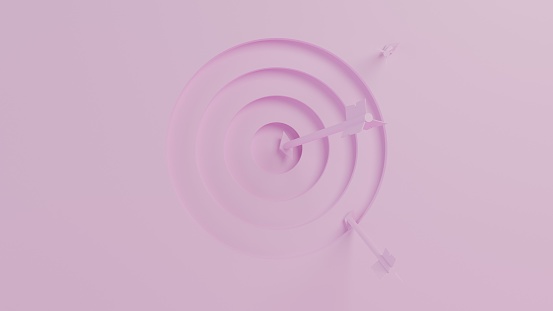 Three giant arrows wedged into a stepped three dimensional target recessed into a smooth wall. One arrow has hit the center while the other two are on the outer surface of the target. Organized in a pink studio environment that is brightly lit. View is from directly centered in front of the target.