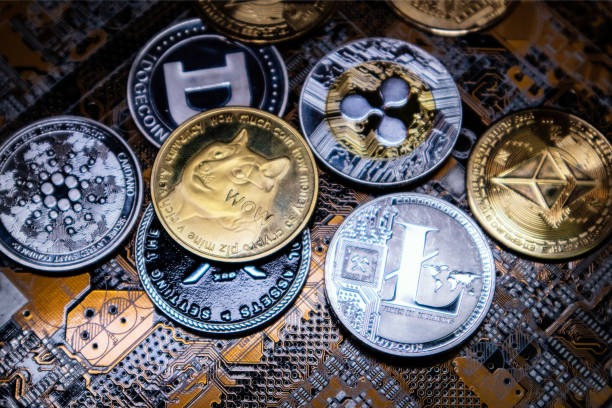 Close up shot of alt coins cryptocurrency over computer circuit stock photo