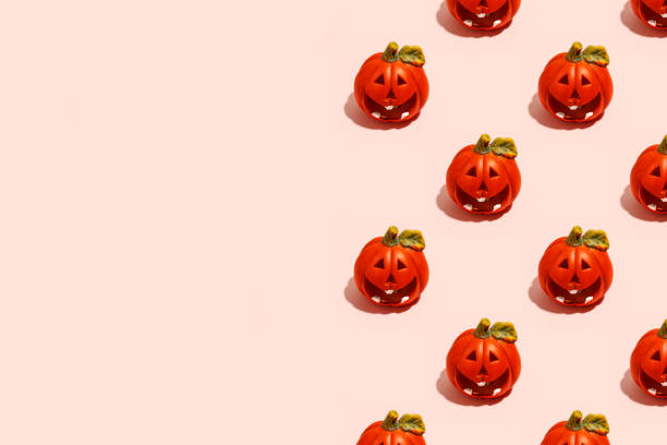 istock Ceramic jack-o-lantern candlestick on pink. Seamless pattern. Halloween concept, hard shadow, banner, printshop, flyer for seasonal party with copy space 1333286669