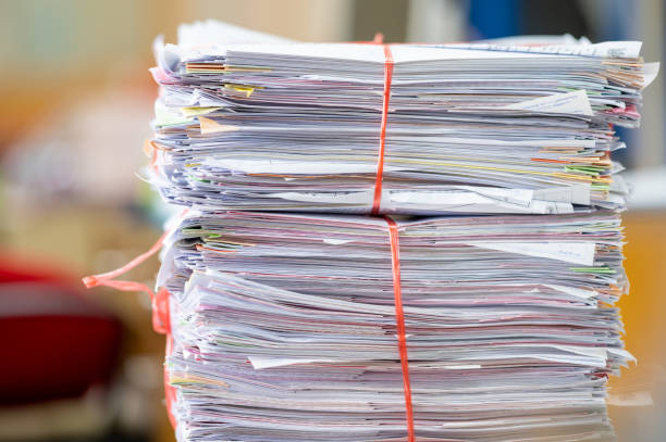 istock Big stack of papers documents or reuse paperwork on office desk stacked concepts of reduce recycle 1333290538
