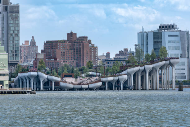 Wide horizontal view seen from the Hudson River of Little Island at Pier 55. An artificial island park in the Hudson River west of Manhattan. New York, NY - USA - July 30, 2011: Wide horizontal view seen from the Hudson River of Little Island at Pier 55. An artificial island park in the Hudson River west of Manhattan. logan west stock pictures, royalty-free photos & images