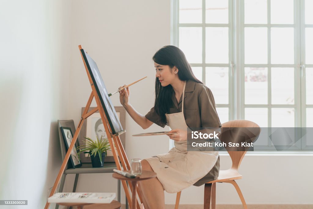 Female Asian painter creating art in her home studio Painting - Activity Stock Photo