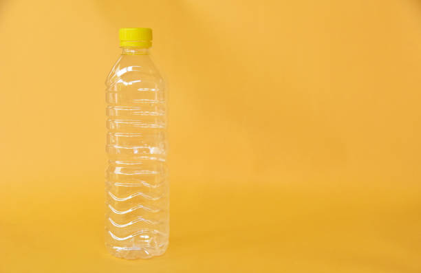 istock Empty water bottle isolated on yellow background 1333311324