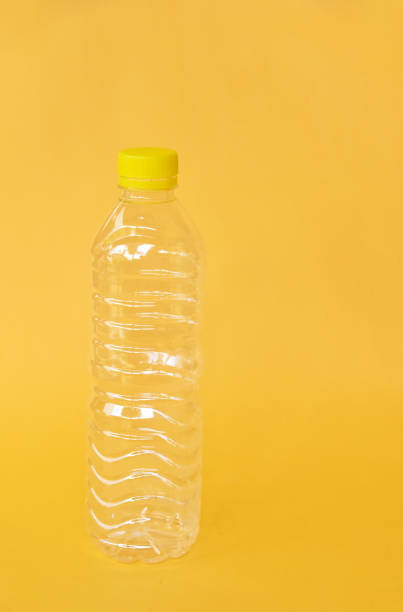istock Empty water bottle isolated on yellow background 1333311875