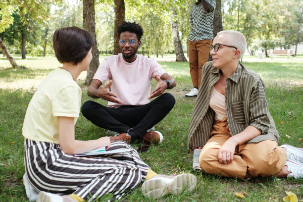 istock Friends talking during meeting in the park 1333311987