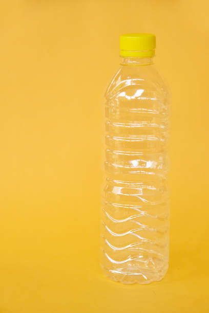 istock Empty water bottle isolated on yellow background 1333312052