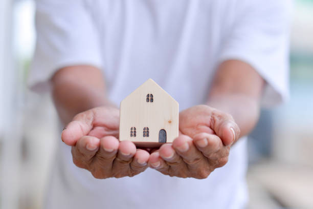 istock toy house in male hand 1333315302