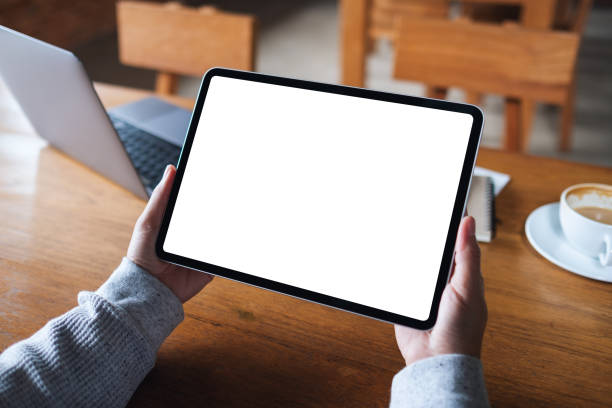 istock a woman holding digital tablet with blank white desktop screen 1333316152