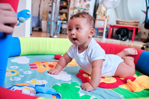istock Baby enjoying while playing on a colorful play mat at home. 1333318289