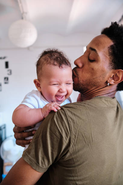 istock Baby smiling and enjoying while his dad holds him in arms. 1333318306