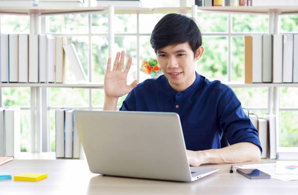 istock Young asian man looking at camera, recording self-presentation video or sharing professional skills. Happy young smart people filming educational lecture. 1333318338