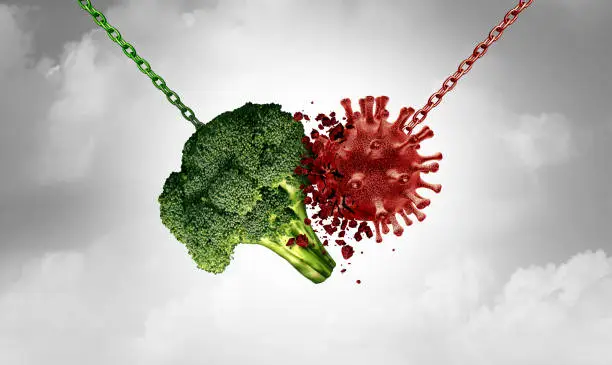 Health food and Disease fighting foods nutrition concept with a healthy broccoli vegetable destroying a virus cell as a healthcare metaphor for a fit lifestyle to attack illness with 3D illustration elements.