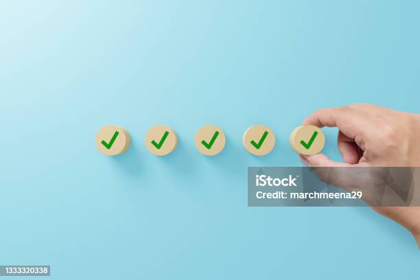Checklist And Check Mark Concept Check Mark On Wooden Blocks On Light Blue Background Stock Photo - Download Image Now