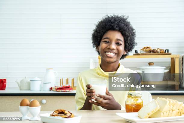 Child Having Breakfast Happy Cute Africanamerican Boy Drinking Milk And Eating Bread With Egg Kids Eat On Sunny Morning Healthy Balanced Nutrition For Young Kids Stock Photo - Download Image Now