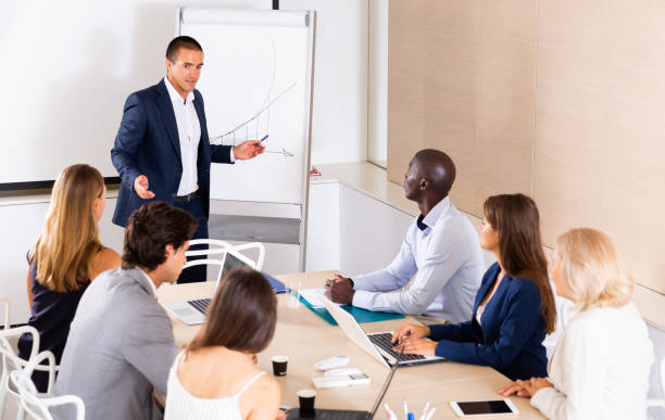 istock Man presenting business project to coworkers 1333322163