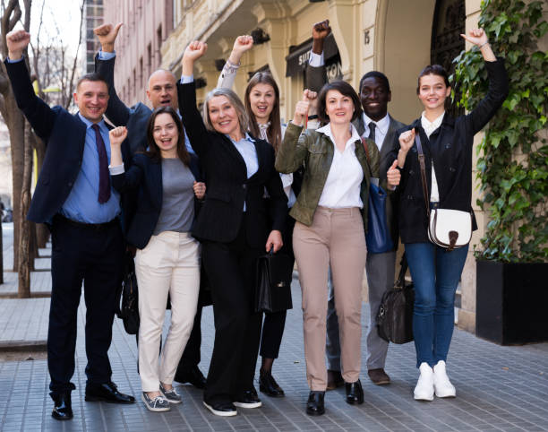 istock Enthusiastic business people on street 1333322909