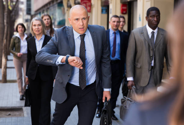 istock Stressed businessman checking time and running 1333322912
